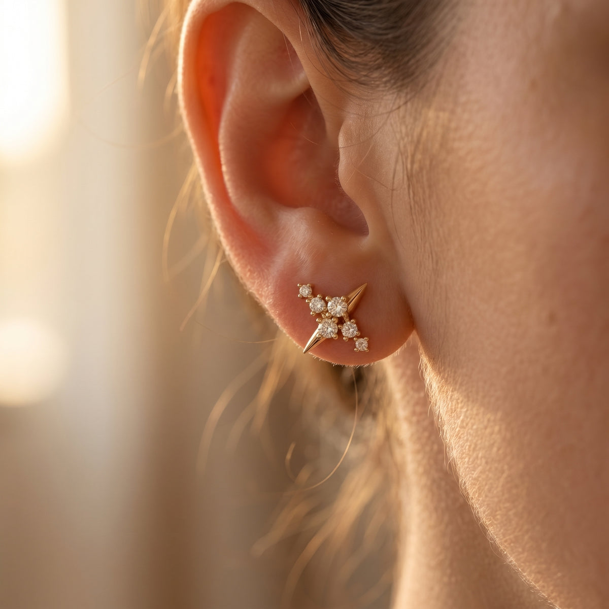 Macro side profile of rose gold diamond stud earrings showing polished finish and fine prong craftsmanship