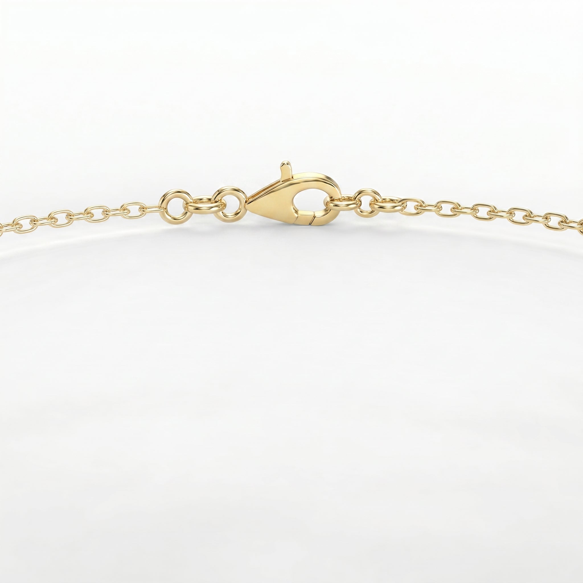 Close-up of round brilliant solitaire stone on delicate yellow gold bracelet with luxury finish