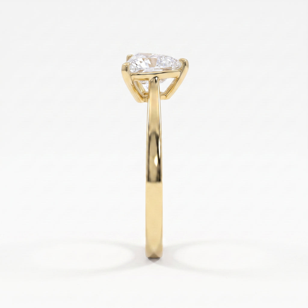 Side profile of a yellow gold solitaire engagement ring showcasing a raised three-prong triangle diamond setting.