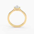 Minimalist traingle cut diamond solitaire engagement ring in polished yellow gold with elegant three-prong setting.