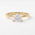 Minimalist triangle cut diamond solitaire engagement ring in polished yellow gold with elegant three-prong setting.