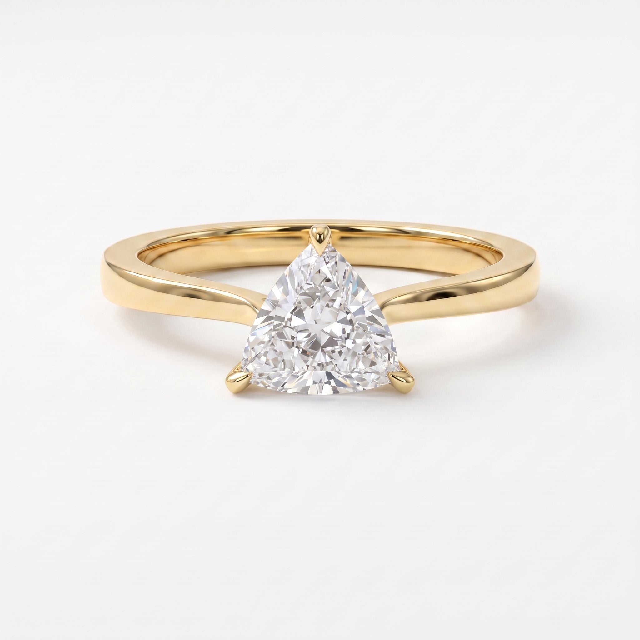 Minimalist triangle cut diamond solitaire engagement ring in polished yellow gold with elegant three-prong setting.