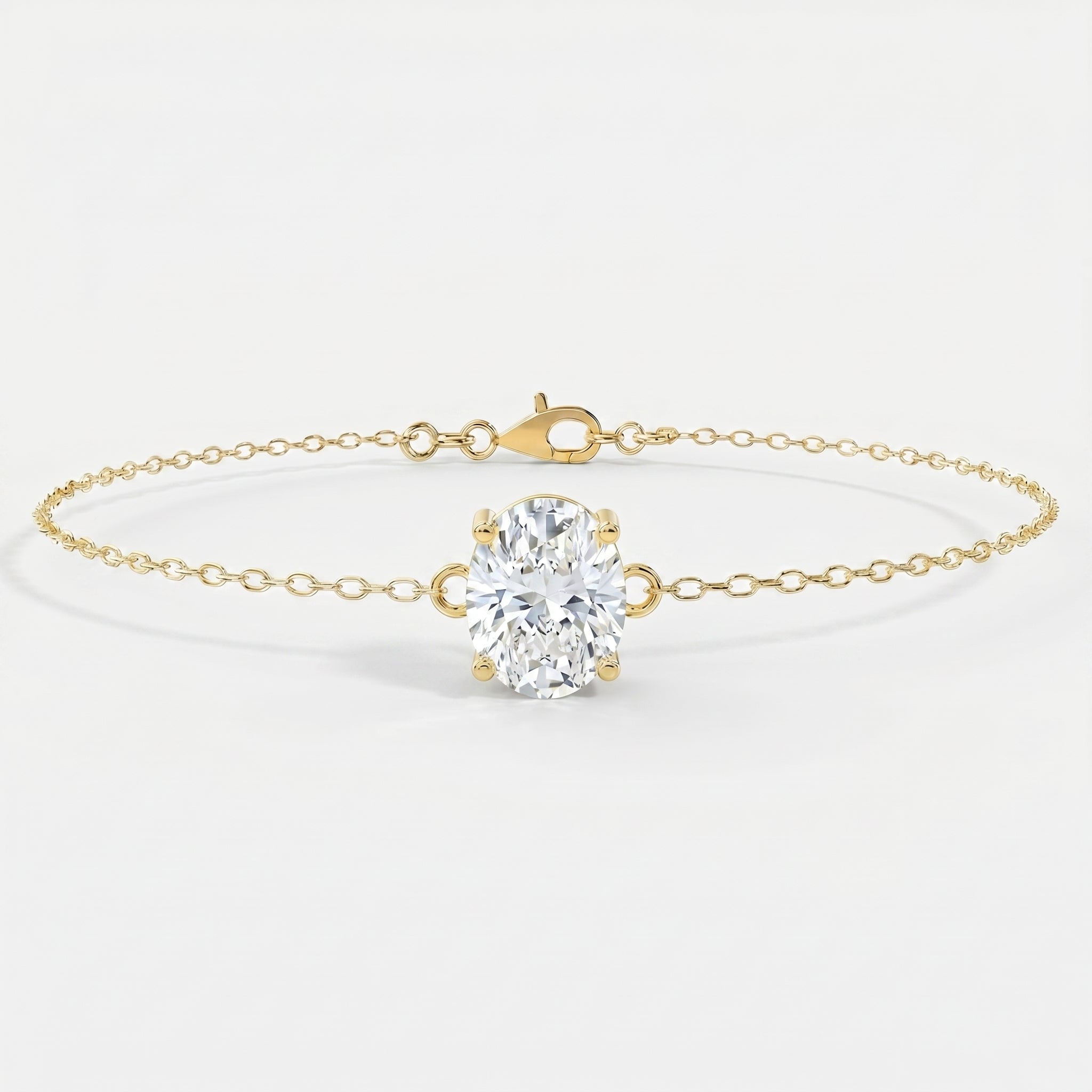 Side profile of oval diamond bracelet showing four-prong yellow gold setting and delicate chain craftsmanship