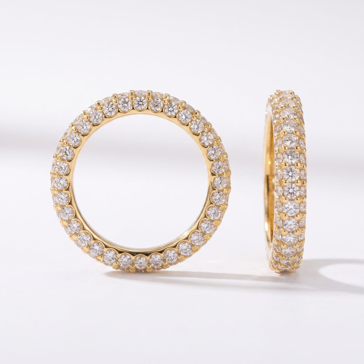 Side profile of a yellow gold diamond eternity band highlighting the three-row pavé setting and premium polished finish.