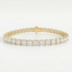 Luxury yellow gold tennis bracelet featuring brilliant Cushion-cut diamonds in a secure prong setting on white background.