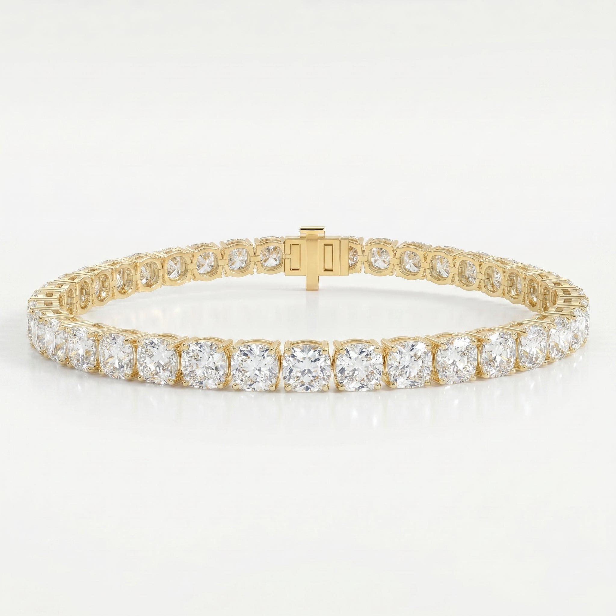 Luxury yellow gold tennis bracelet featuring brilliant Cushion-cut diamonds in a secure prong setting on white background.