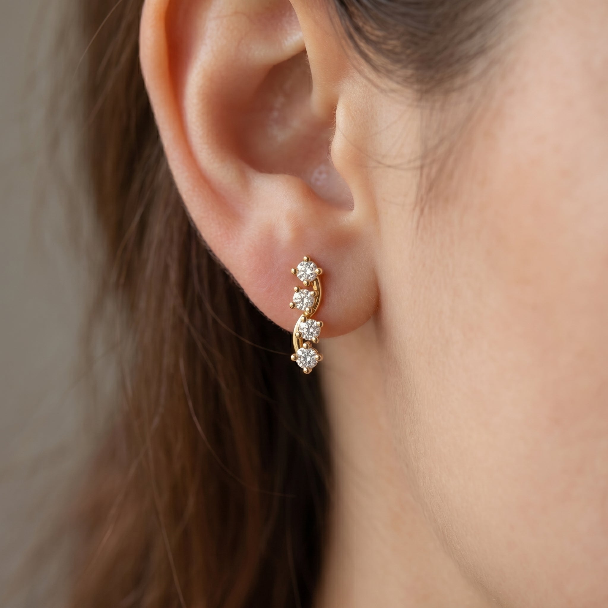 Close-up side profile of Yellow gold diamond ear climber earrings with premium prong stone settings