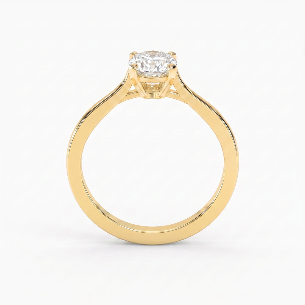 Front view of a yellow gold oval diamond solitaire engagement ring featuring a secure four-prong setting and elegant minimalist band.